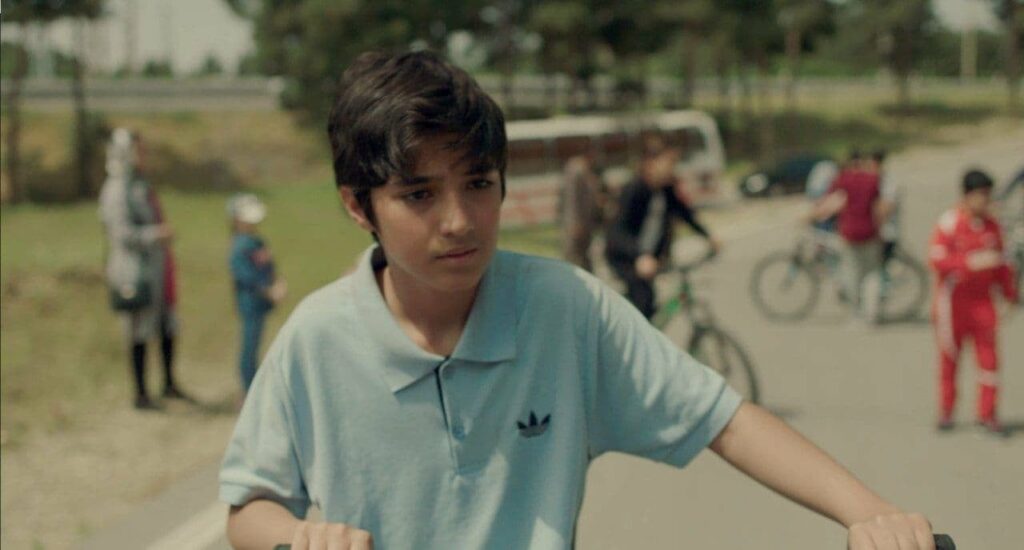Image from 'The Winner' short film. Young boy with his bike.