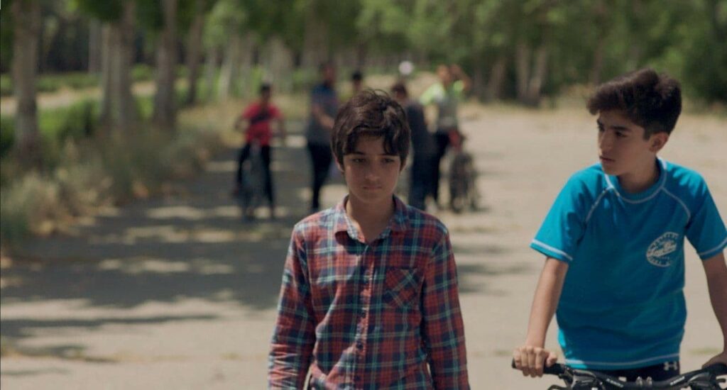 Image from THE WINNER short (Iran). Vahid and another boy walking on a dirt path